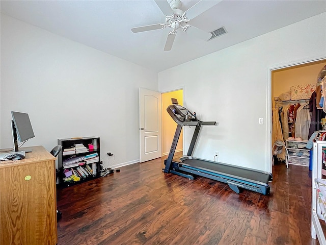 workout area with dark wood-type flooring and ceiling fan