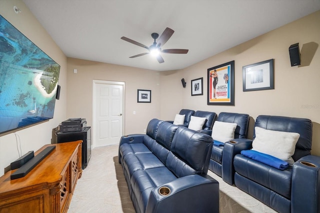 home theater room with light colored carpet and ceiling fan