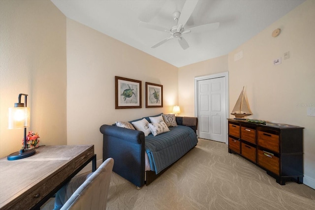 interior space featuring a ceiling fan, a closet, and light carpet