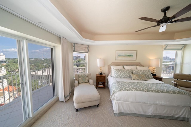 carpeted bedroom featuring a ceiling fan and access to outside