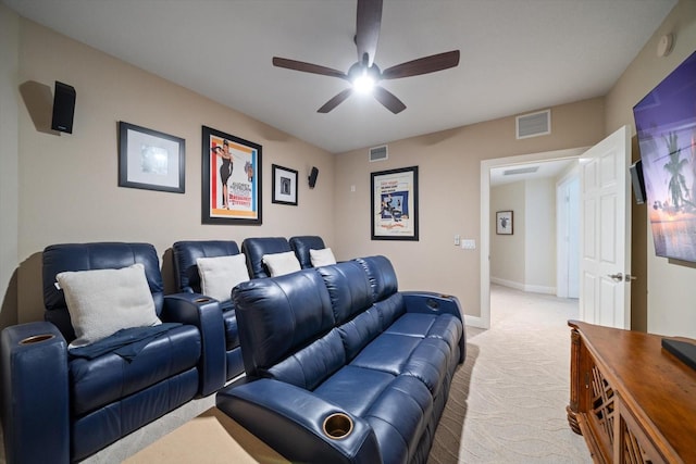 cinema room with a ceiling fan, visible vents, light carpet, and baseboards