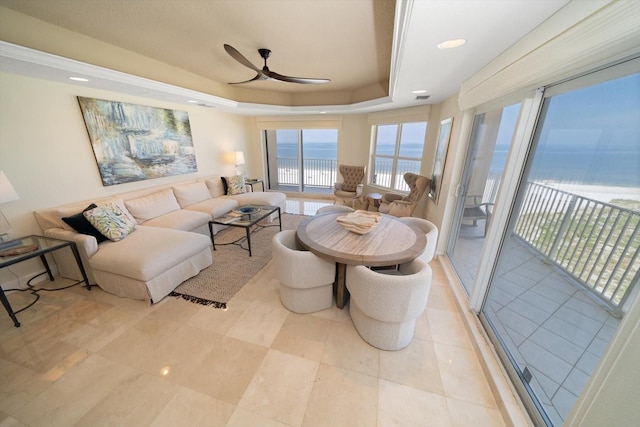 living area featuring recessed lighting, a raised ceiling, ceiling fan, a water view, and light tile patterned flooring