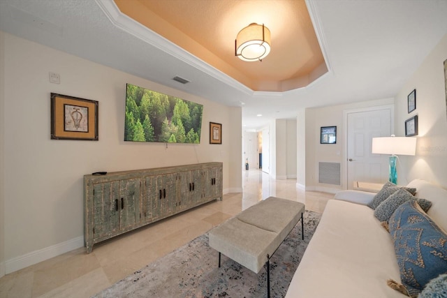 living room featuring a raised ceiling, visible vents, and baseboards