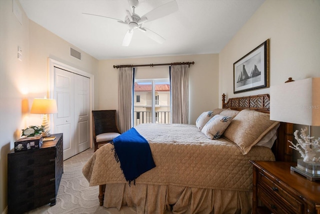 bedroom with a closet, visible vents, ceiling fan, and light carpet