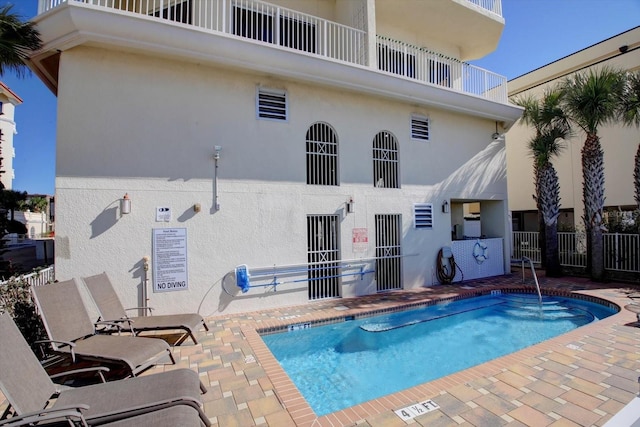 pool with fence and a patio