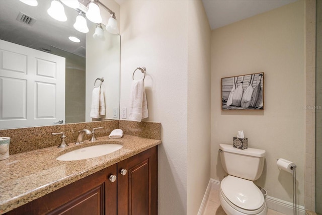 bathroom with toilet, vanity, visible vents, baseboards, and tile patterned floors