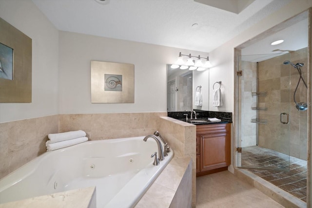 full bathroom with tile patterned floors, a shower stall, vanity, and a tub with jets