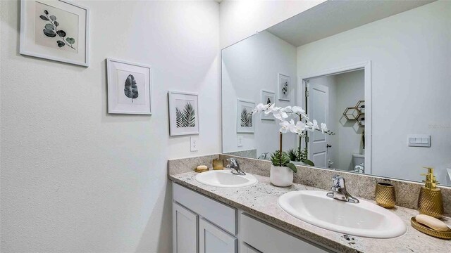 bathroom featuring vanity and toilet