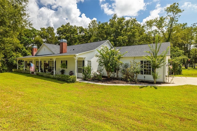 view of front facade with covered porch and a front lawn