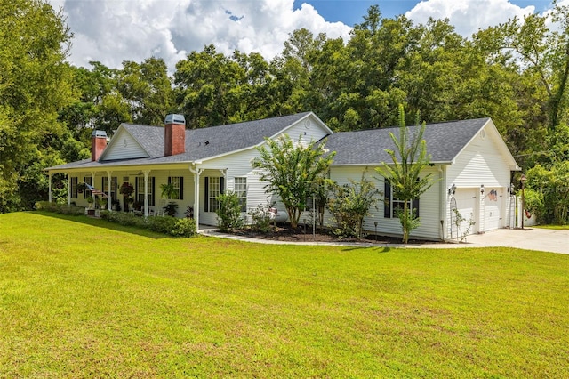 view of front of property with a front yard, covered porch, and a garage