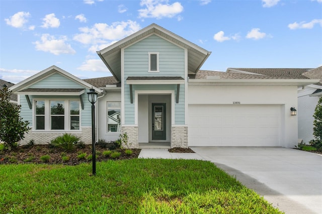 front facade with a front yard and a garage