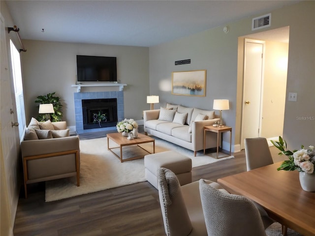 living room featuring hardwood / wood-style floors and a tile fireplace