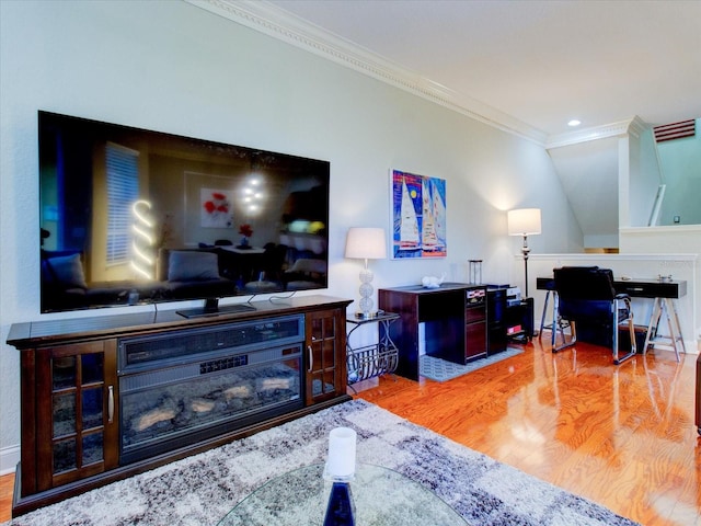 living room featuring hardwood / wood-style floors and crown molding