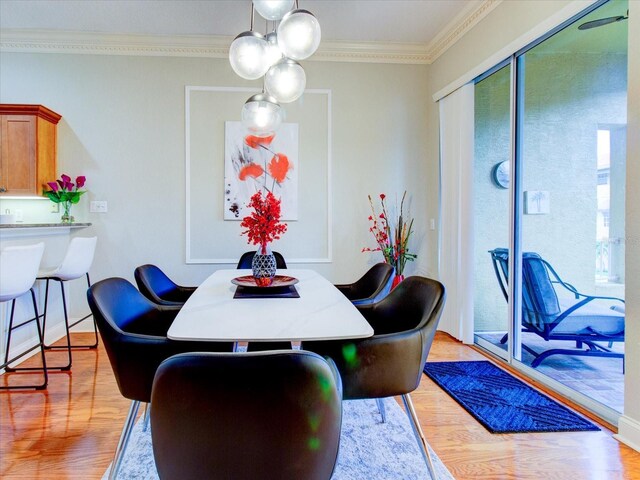 dining room with wood-type flooring and ornamental molding