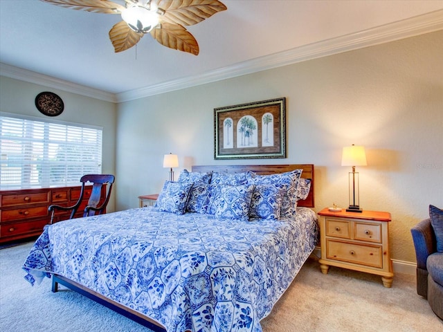 carpeted bedroom featuring crown molding and ceiling fan