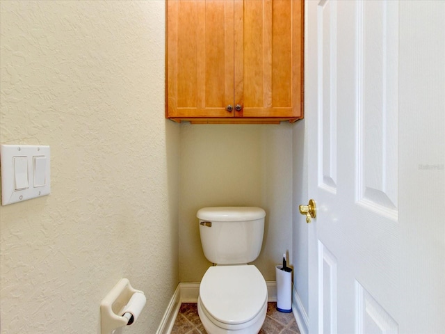 bathroom featuring toilet and tile patterned floors