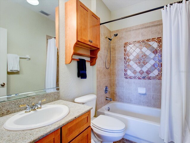 full bathroom with vanity, toilet, and shower / tub combo with curtain