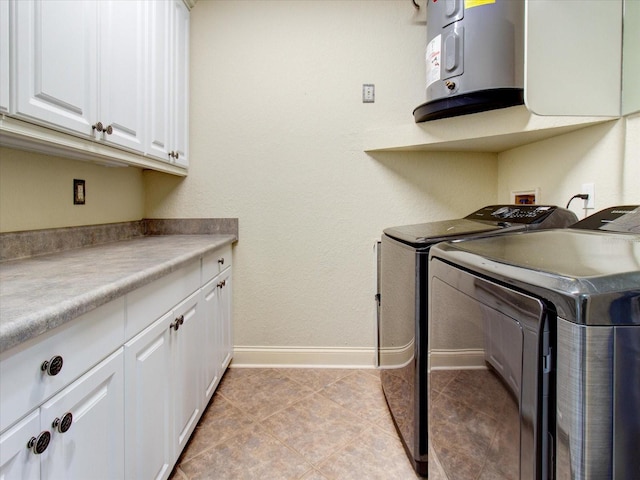 washroom with water heater, light tile patterned floors, cabinets, and separate washer and dryer