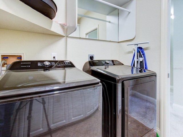 clothes washing area with washer and clothes dryer