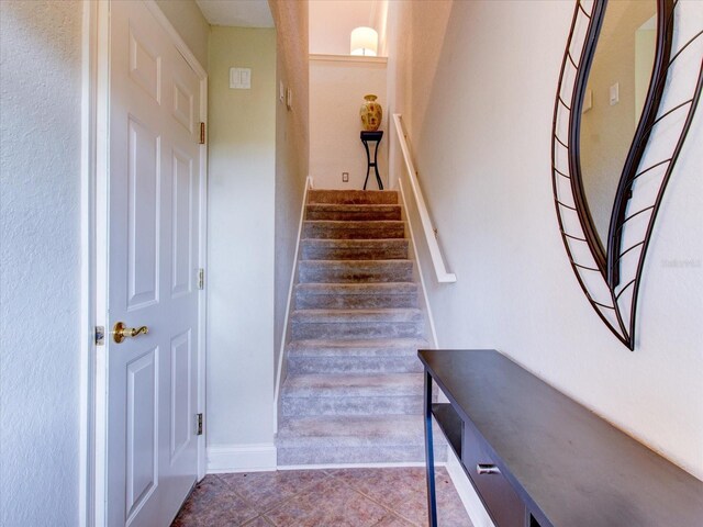 stairs with tile patterned floors