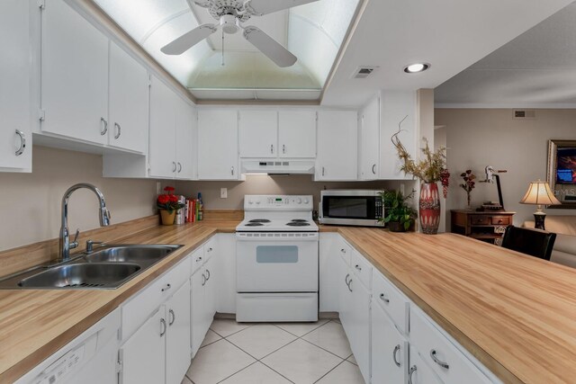 kitchen featuring white appliances, visible vents, a sink, white cabinets, and under cabinet range hood