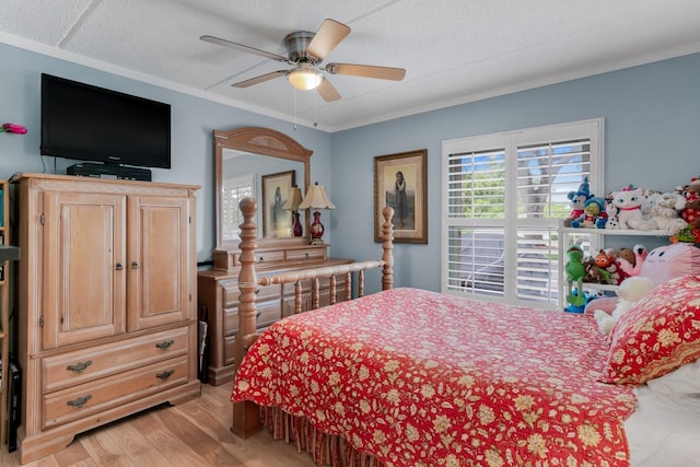 bedroom with crown molding, light wood-style flooring, a ceiling fan, and a textured ceiling