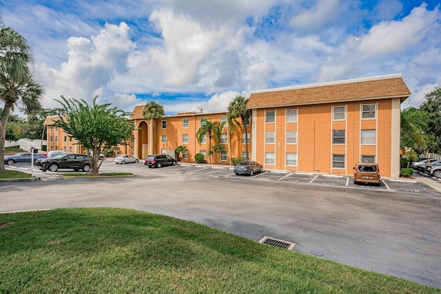 view of property featuring uncovered parking