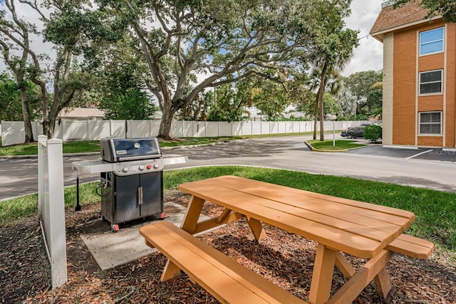 view of patio with area for grilling and fence