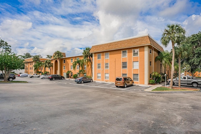 view of building exterior featuring uncovered parking