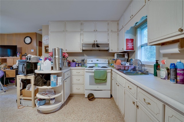 kitchen with white cabinetry, wood walls, sink, and white electric range oven