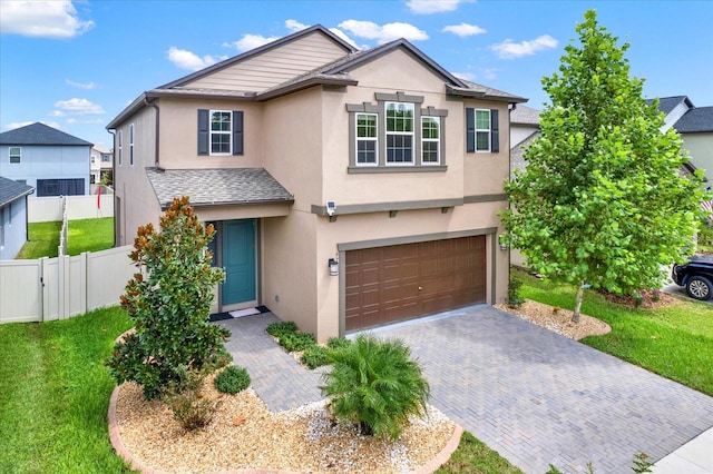 front facade featuring a garage and a front lawn