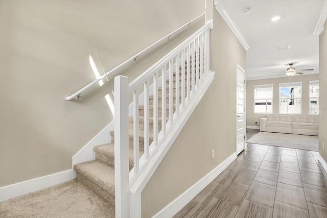 stairs featuring a ceiling fan, baseboards, visible vents, recessed lighting, and crown molding