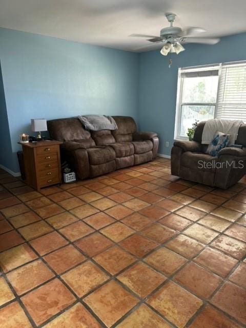 living room with ceiling fan and tile patterned flooring