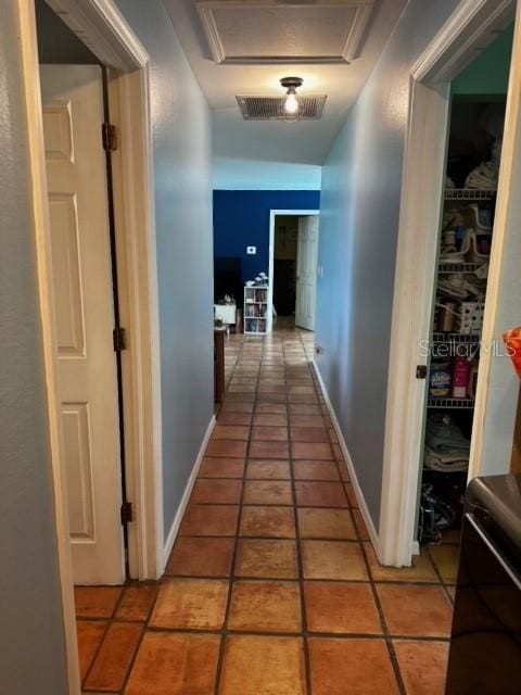 corridor featuring light tile patterned flooring