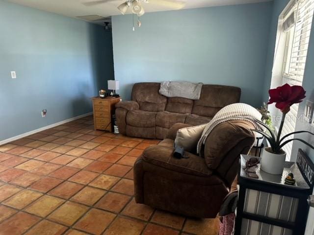 tiled living room featuring ceiling fan