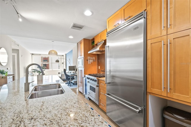 1120 E Kennedy Blvd Unit 734, Tampa, FL 33602 - kitchen featuring light stone counters, high end appliances, visible vents, a sink, and under cabinet range hood