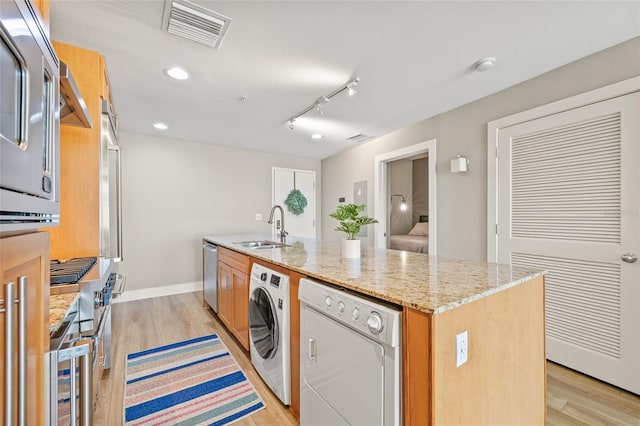 1120 E Kennedy Blvd Unit 734, Tampa, FL 33602 - kitchen featuring washer / dryer, visible vents, stainless steel dishwasher, and a sink