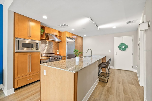 1120 E Kennedy Blvd Unit 734, Tampa, FL 33602 - kitchen with visible vents, light wood-style floors, built in appliances, under cabinet range hood, and a sink