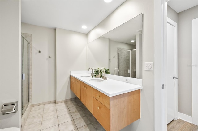 1120 E Kennedy Blvd Unit 734, Tampa, FL 33602 - bathroom with double vanity, tile patterned flooring, a shower stall, and a sink