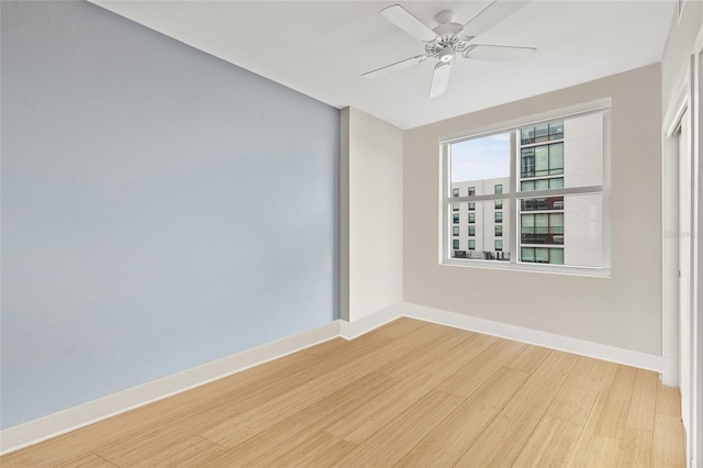 1120 E Kennedy Blvd Unit 734, Tampa, FL 33602 - unfurnished room featuring ceiling fan, light wood-style flooring, and baseboards