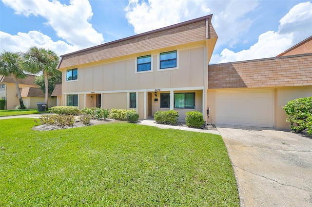 view of front of home featuring a garage and a front yard