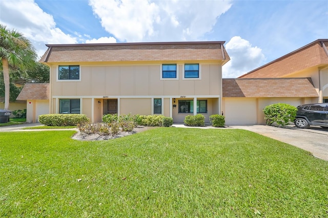 view of front of property featuring a garage and a front lawn