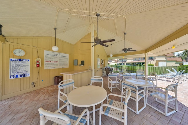 view of patio featuring a bar and ceiling fan