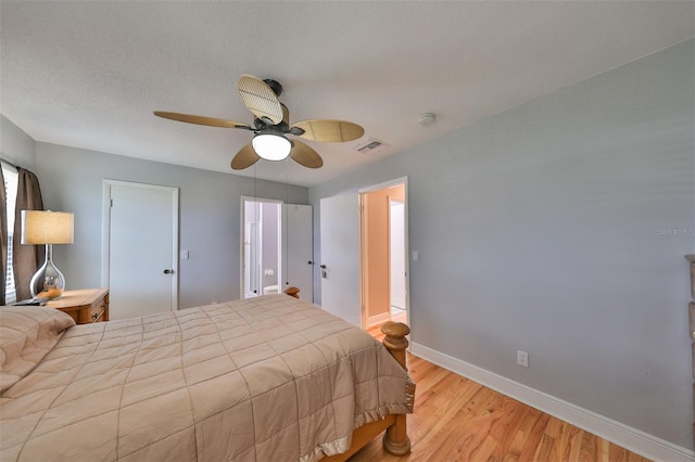 bedroom featuring a textured ceiling, light hardwood / wood-style flooring, and ceiling fan