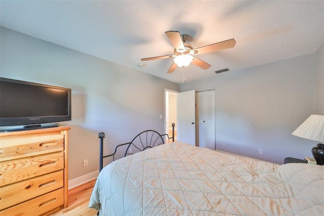 bedroom featuring a closet, ceiling fan, and light hardwood / wood-style floors