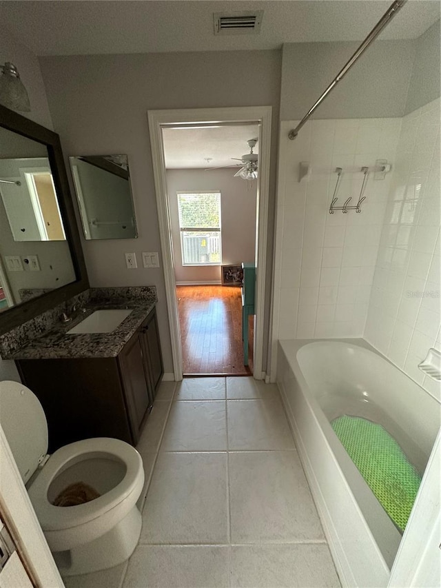 bathroom featuring visible vents, toilet, tile patterned flooring, tub / shower combination, and vanity