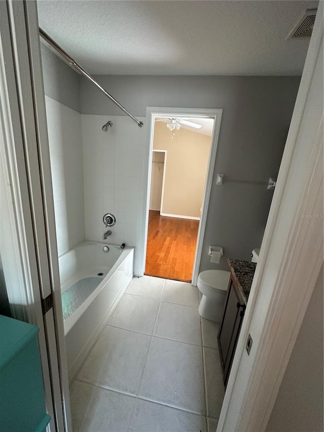 full bathroom featuring visible vents, toilet, tile patterned flooring, a textured ceiling, and vanity