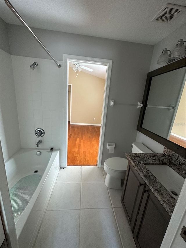 full bath featuring visible vents, toilet, tile patterned floors, a textured ceiling, and vanity