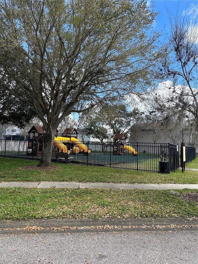 surrounding community featuring a lawn, fence, and playground community