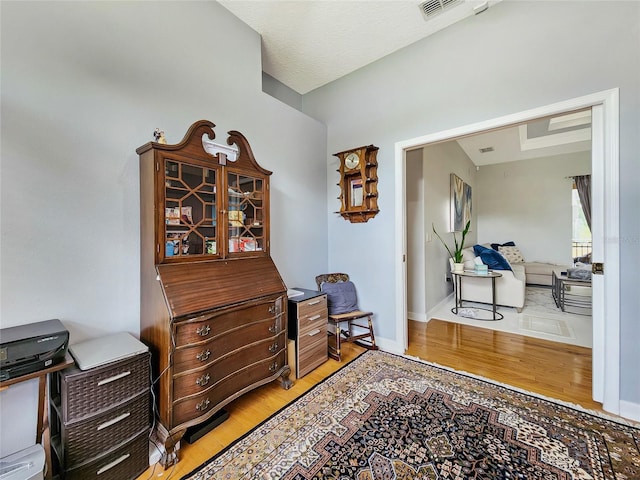 interior space featuring a textured ceiling and hardwood / wood-style flooring